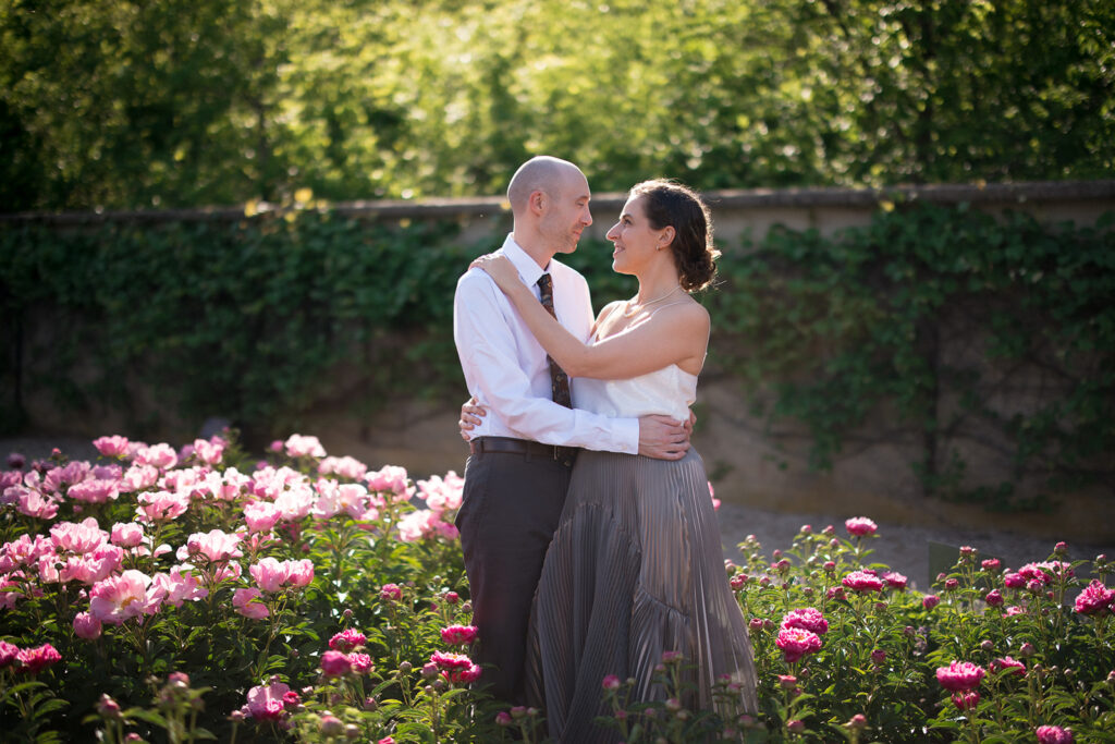 Couple embracing among blooming peonies at Allerton Park in Monticello Illinois
