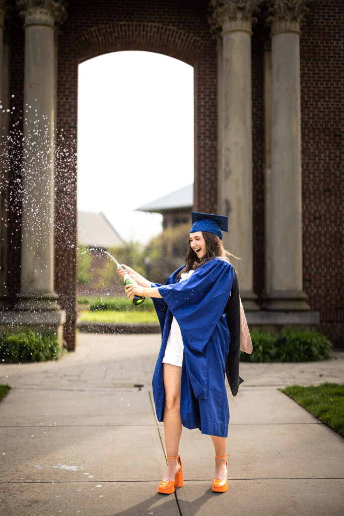 University of Illinois graduate celebrating at Hallene Gateway in Champaign-Urbana