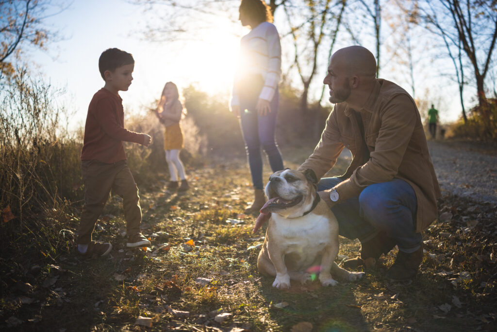 Family gathered outdoors at River Bend Forest Preserve in Mahomet, IL, enjoying a sunny autumn day, captured by Light By Zoey Photography, Champaign, IL."