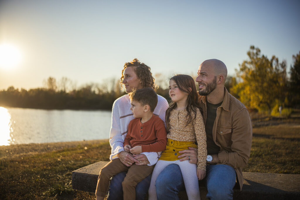 Family gathered outdoors at River Bend Forest Preserve in Mahomet, IL, enjoying a sunny autumn day, captured by Light By Zoey Photography, Champaign, IL."