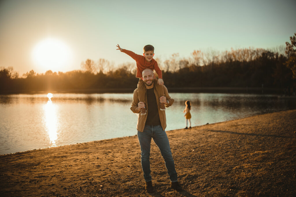 : "Family enjoying time by the lake at River Bend Forest Preserve in Mahomet, IL, with a golden sunset, captured by Light By Zoey Photography, Champaign, IL."