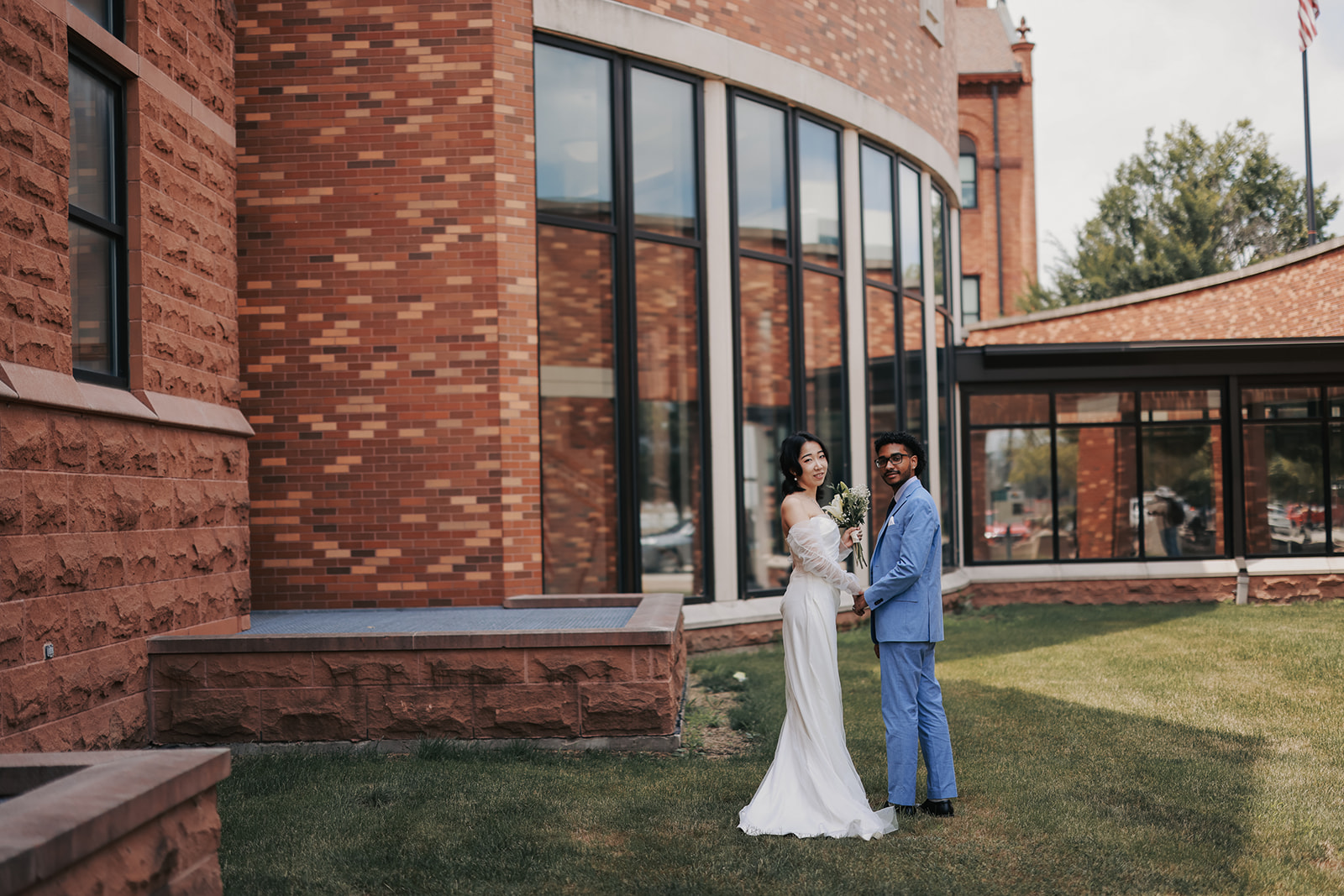 Bride and groom portrait outside Champaign County Courthouse in Urbana Illinois after their courthouse wedding ceremony