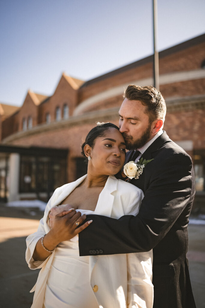 Newly married couple embracing outside the Champaign County Courthouse in Champaign, Illinois.