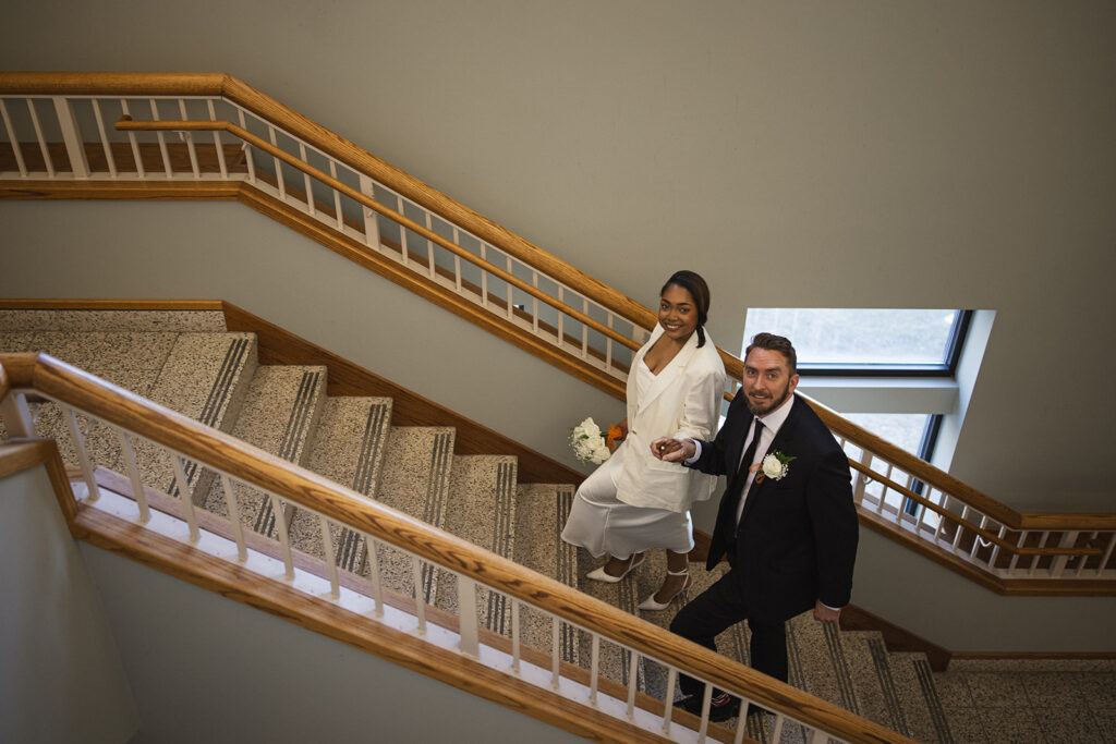 Bride and groom walking up the courthouse staircase during their Champaign County courthouse wedding in Illinois.