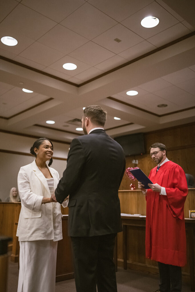 Couple holding hands during their courthouse wedding ceremony in Urbana, Illinois.