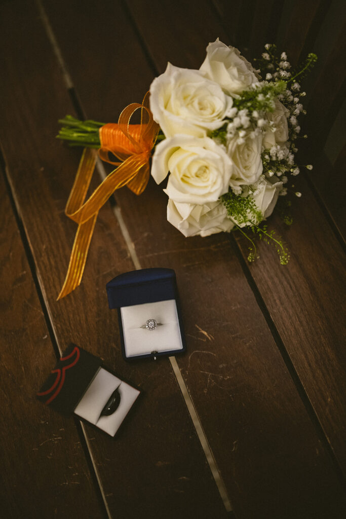 Wedding rings and white rose bouquet photographed during a courthouse wedding in Urbana, Illinois.